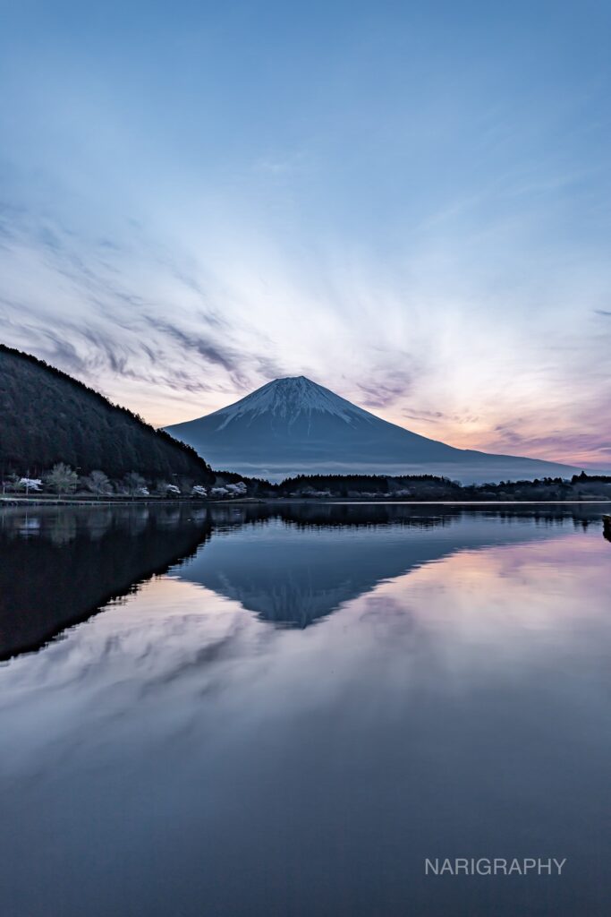 Mount Fuji reflected on a calm lake during early morning in Japan